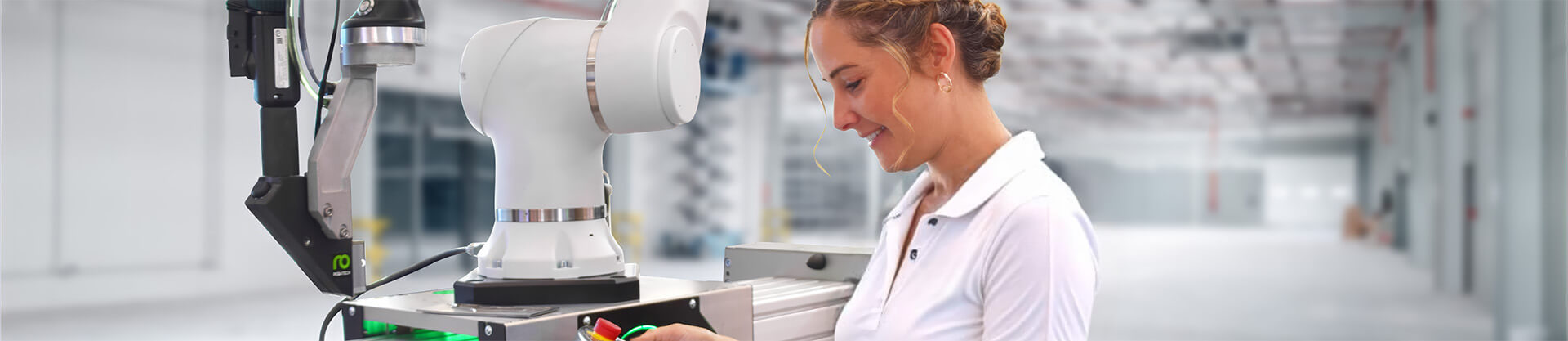 Woman operating robot-assisted adhesive application via mobile panel. 